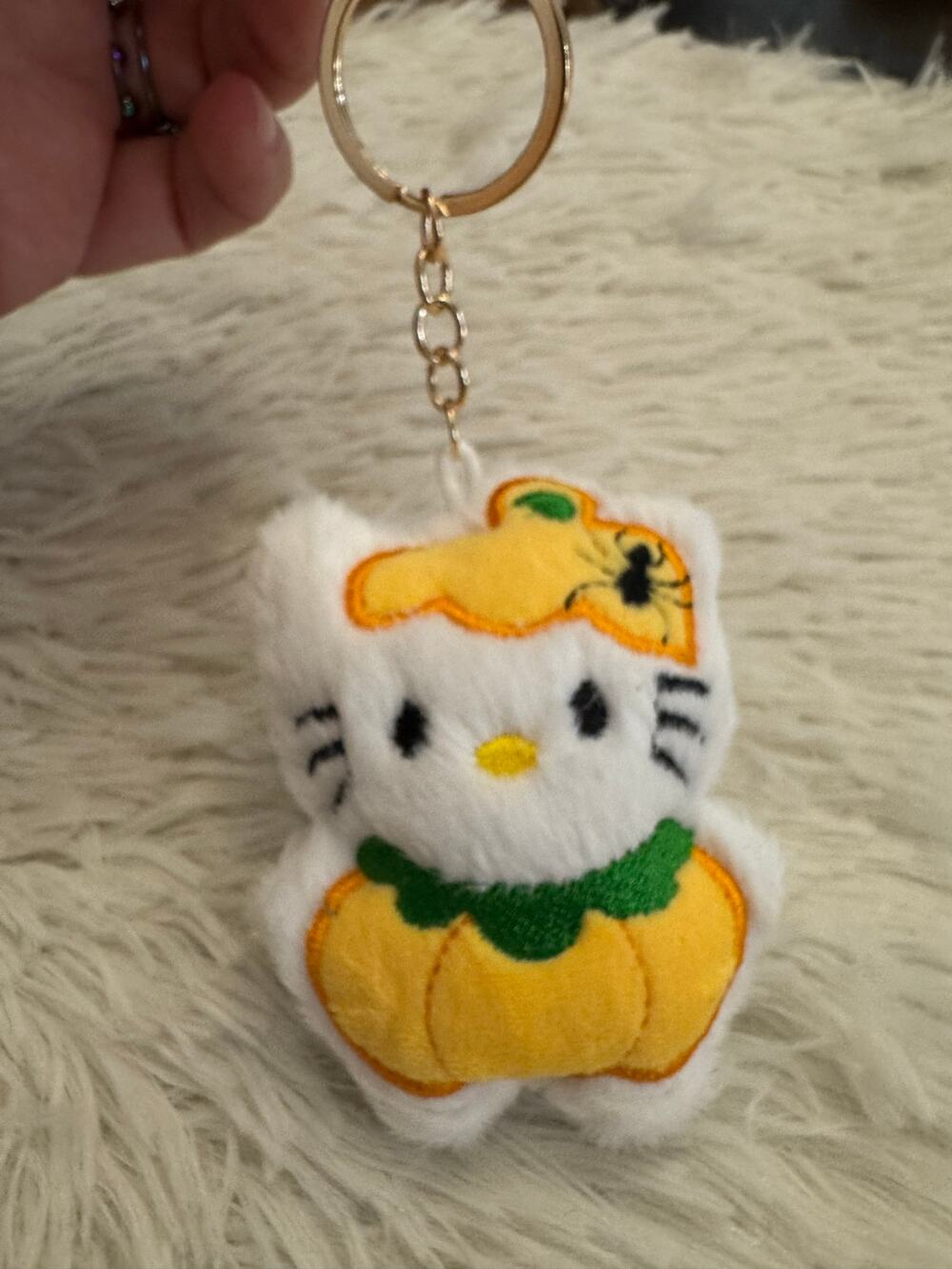 Hello Kitty pumpkin plush keychain with yellow pumpkin design and green stem